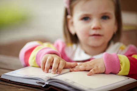 little girl reads book