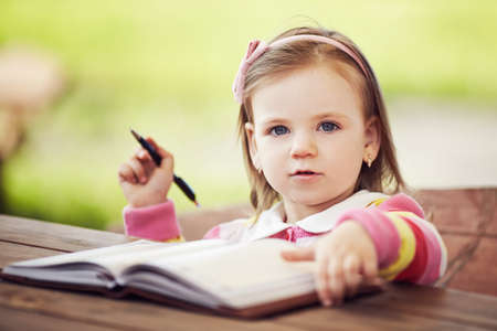 cute little girl learning to writeの写真素材