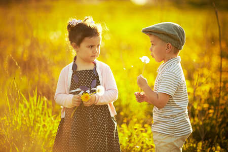 boy and girl in summer fieldの写真素材