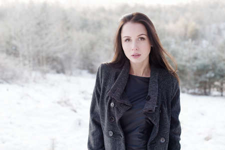 beautiful girl alone in winter forest
