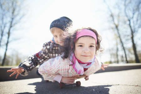 boy and pretty girl skaiting on the streetの写真素材