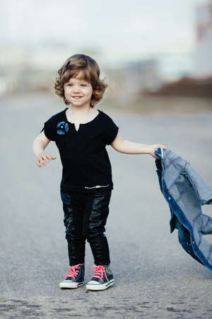 little girl with denim jacket on the street