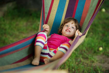 little cute girl resting lying on hammockの写真素材