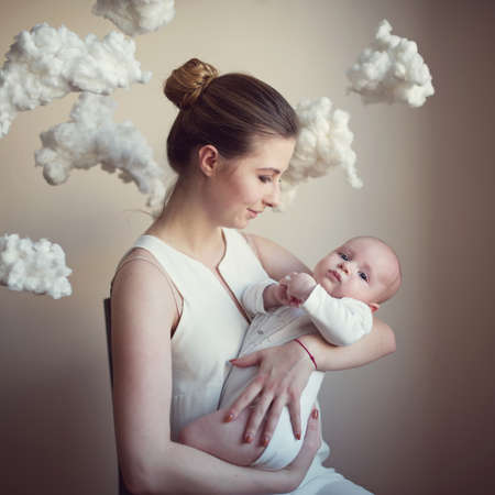 mother with baby on white clouds background