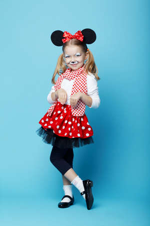 little beautiful girl with mouse mask on blueの写真素材