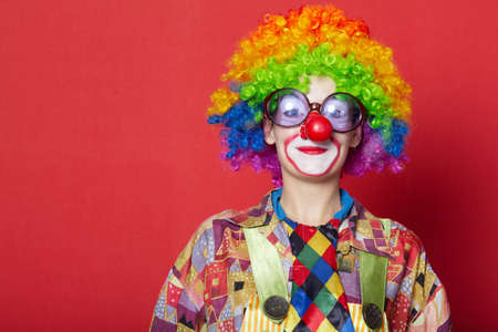 funny clown with glasses on red backroundの写真素材