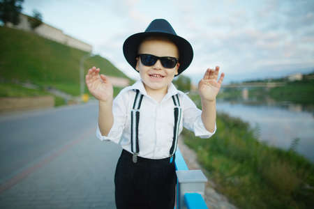 photo of little gentleman with sunglasses outdoors portraitの写真素材