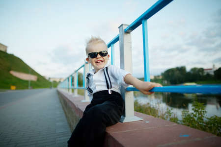 photo of little gentleman with sunglasses outdoors portraitの写真素材
