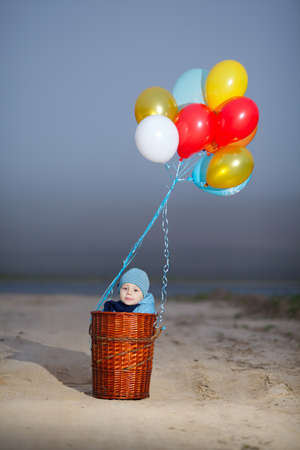little boy wants to fly on balloons awayの写真素材