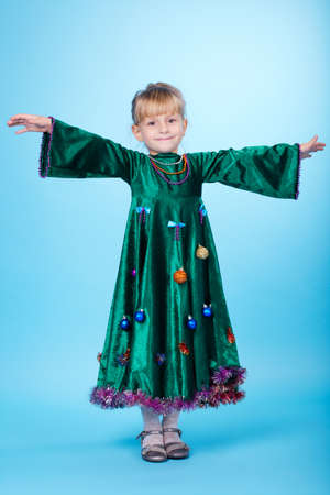 cute little girl with christmas tree dressの写真素材