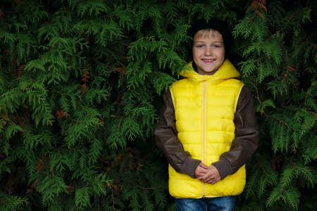 portrait of cute little boy in yellow vestの写真素材