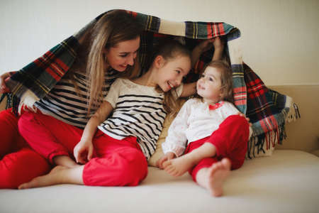beautiful mother and daughter at home photoの写真素材