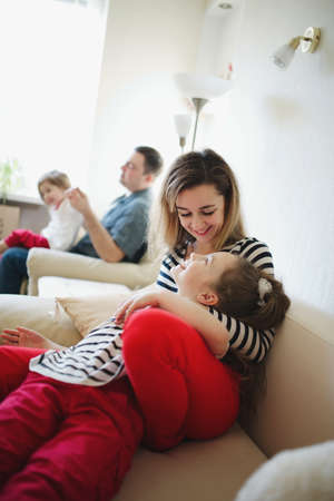 beautiful mother and daughter at home photoの写真素材