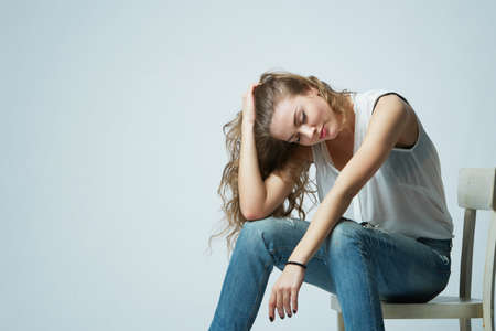 beautiful girl with long hair posing on chairの写真素材