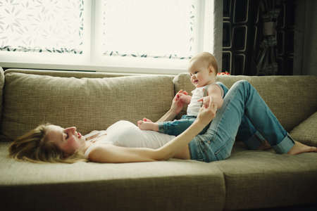 beautiful young mother with baby at homeの写真素材