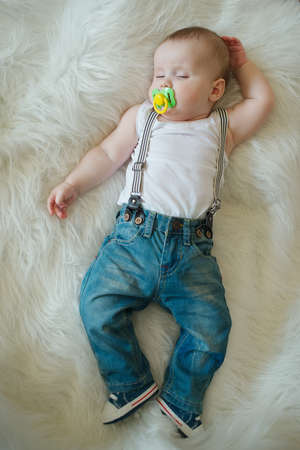 photo of cute little sleeping boy at fur