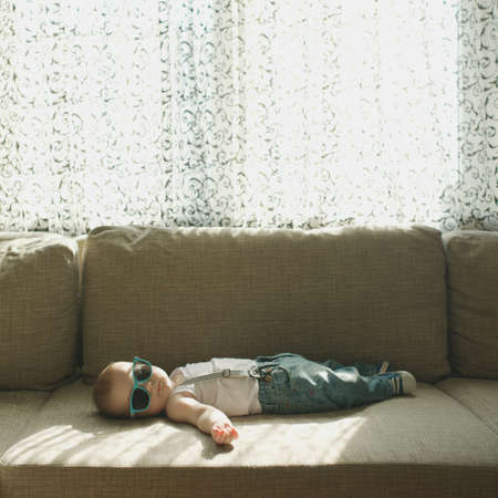 photo of cute little sleeping boy at furの写真素材