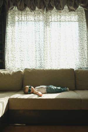 photo of cute little sleeping boy at fur