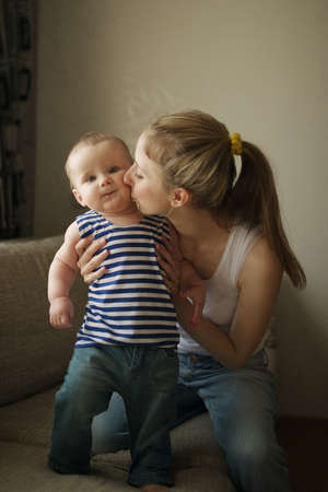 beautiful young mother with baby at home