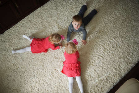 photo of little boy with two girls twinsの写真素材