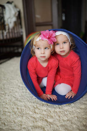 photo of two cute twin girls portraitの写真素材