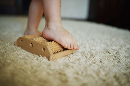 little happy boy massage feet on massagerの写真素材