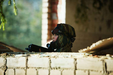 Little boys playing with gun during lasertagの写真素材