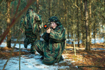 Little boys playing with gun during lasertagの写真素材
