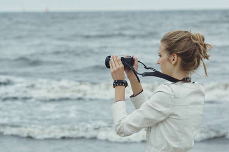 photo of beautiful youn girl with cameraの写真素材