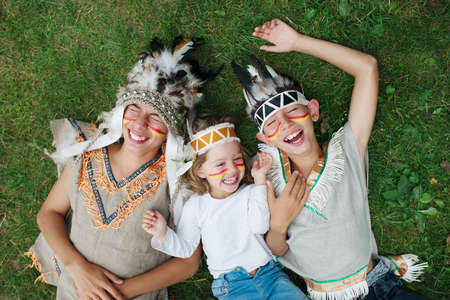 photo of happy children with native american costumes