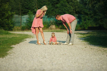 photo of cute little boy with his parents outdoorsの写真素材