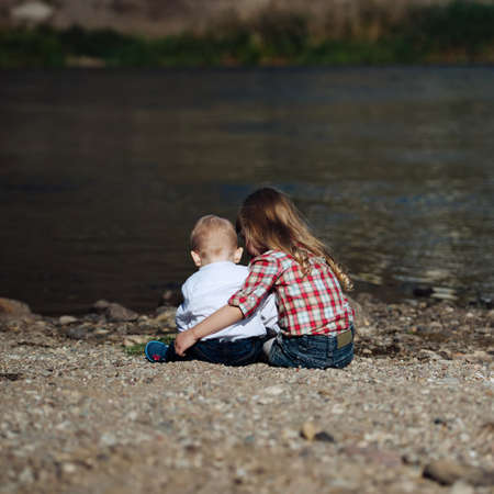 photo of boy and girl on the riverの写真素材