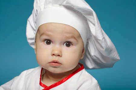 photo of cute little baby with chef hatの写真素材