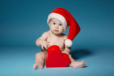 little boy in diapers with hat of Santa Clausの写真素材
