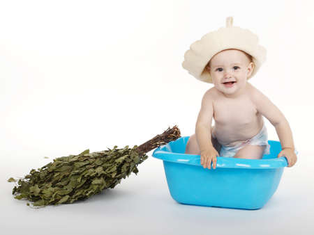 little boy with bath hat and broomの写真素材