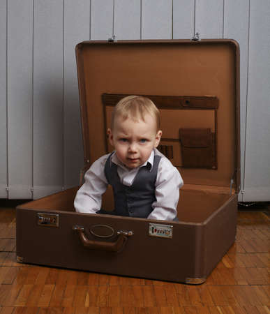 photo of little funny boy in suitcaseの写真素材