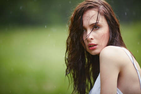 beautiful girl under rain in summer forestの写真素材