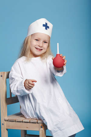photo of little funny girl playing nurseの写真素材