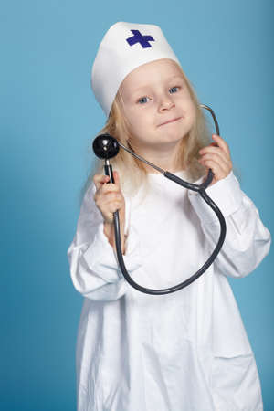 little funny girl playing nurse studio photoの写真素材