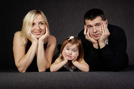 photo of happy family on dark backgroundの写真素材