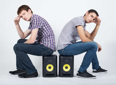 photo of two funny boys with speakersの写真素材