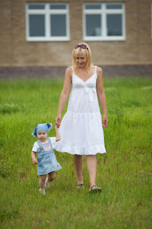 young mother with daughter in summer parkの写真素材
