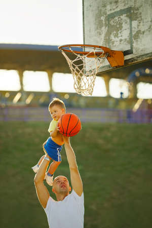 father and son playing basketball in the streetの写真素材