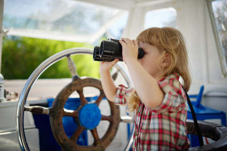 photo of little sweet girl on yachtの写真素材