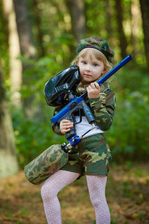 little girl in camouflage suit with rifleの写真素材