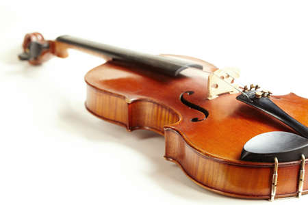 aged handmade violin isolated on white backgroundの写真素材