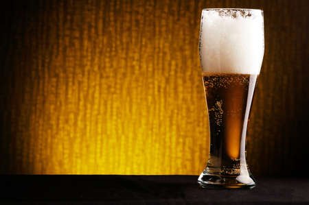 photo of glass of beer on dark backgroundの写真素材
