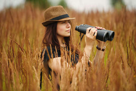 Young beautiful girl in high grass portraitの写真素材