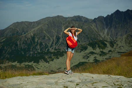 photo of young beautiful girl climbing the rock