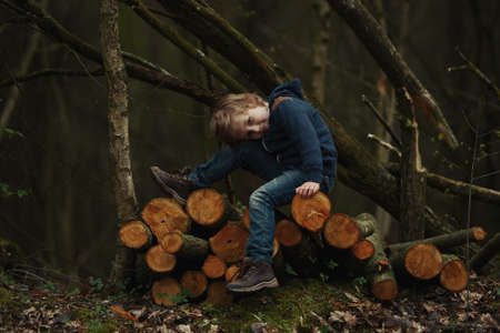 photo of little sweet lumberjack in autumn forestの写真素材